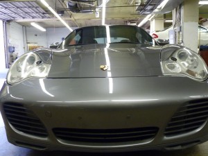 A silver car is parked in the garage.