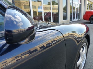 The closer look at the side of a black Porsche 911 (996)