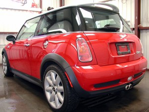 A red mini cooper parked in a garage.