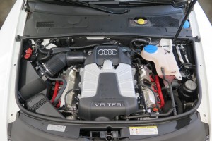 A car engine with the hood open.