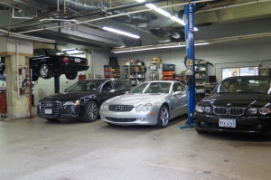 A garage with several cars parked in it.