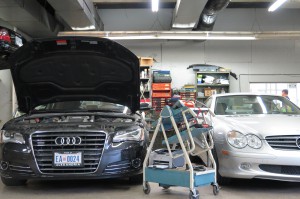 A car is parked in the garage with other cars.