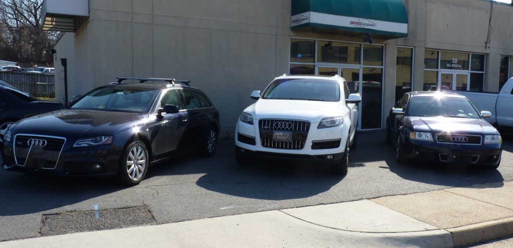 Two cars parked in a parking lot next to each other.