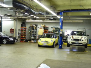 A garage with cars parked on the floor