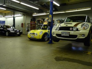 A couple of cars are parked in a garage