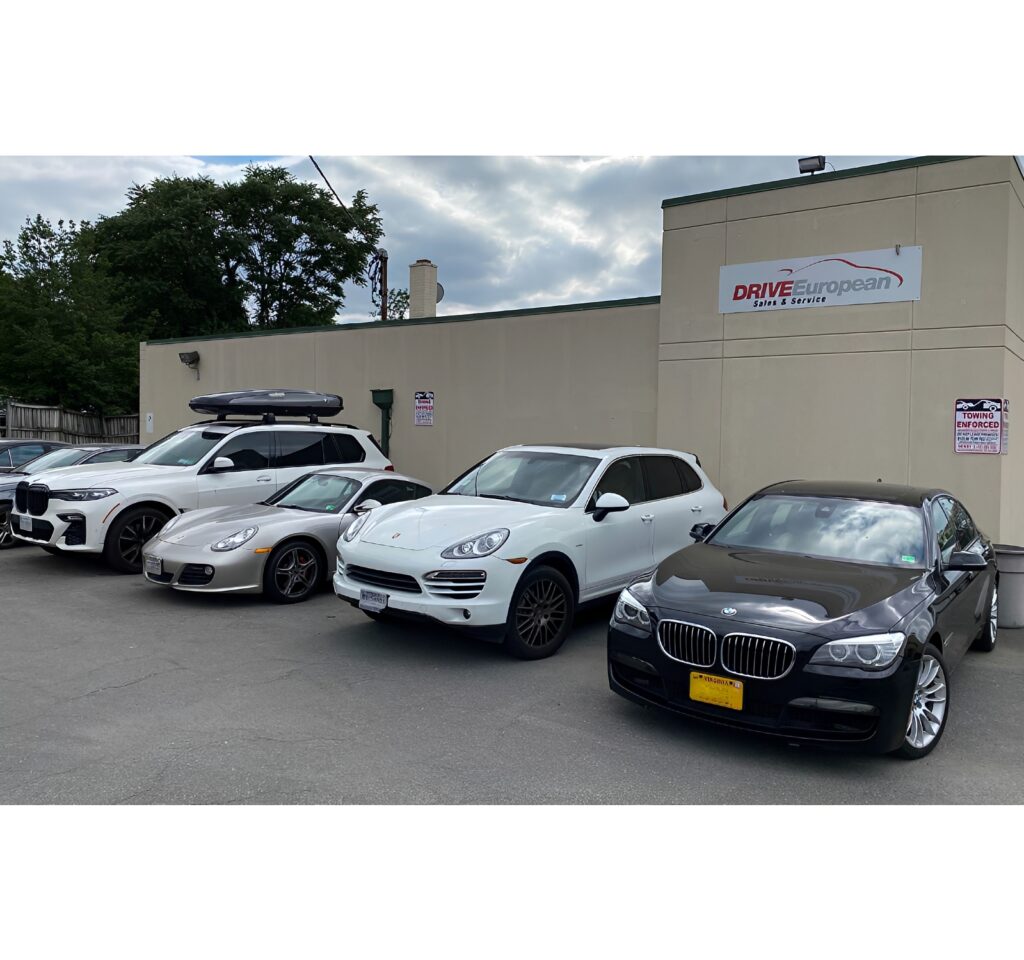Row of luxury cars parked outside dealership